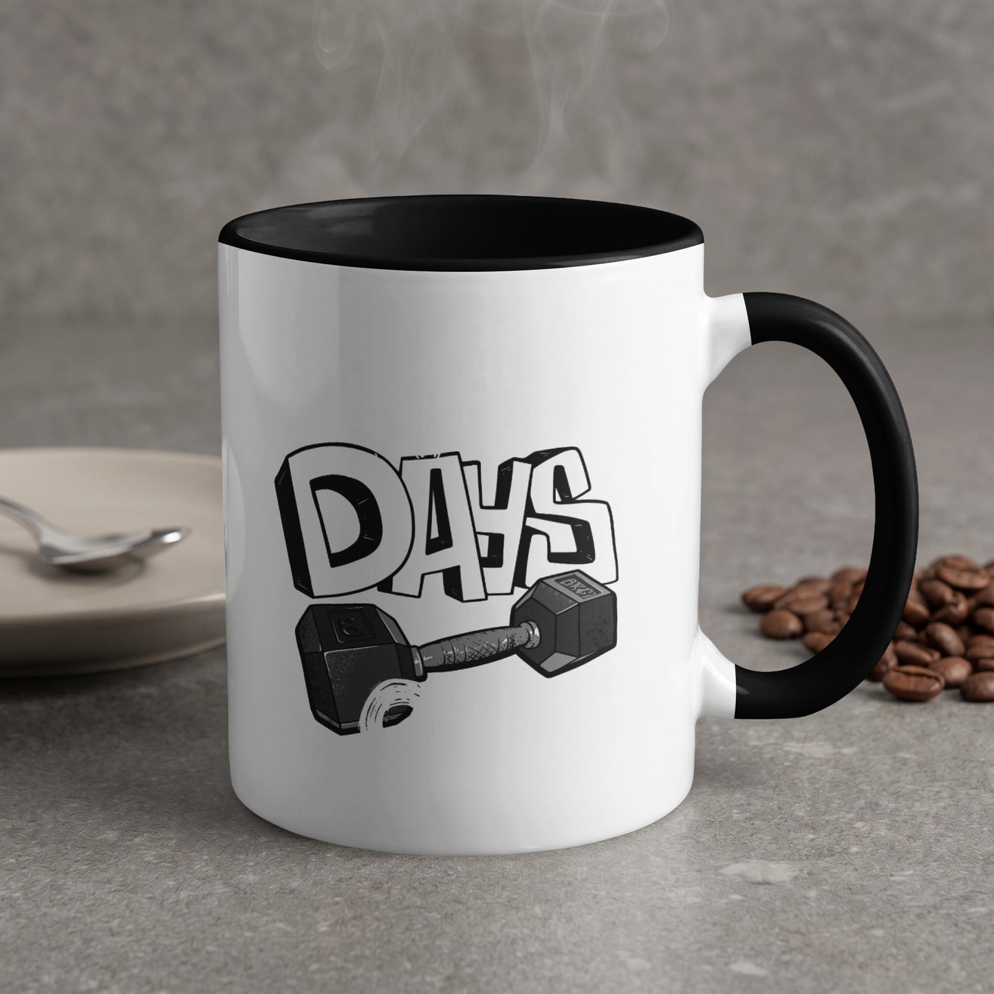 White mug with black rim, "DAYS" text and dumbbell graphic, coffee beans.