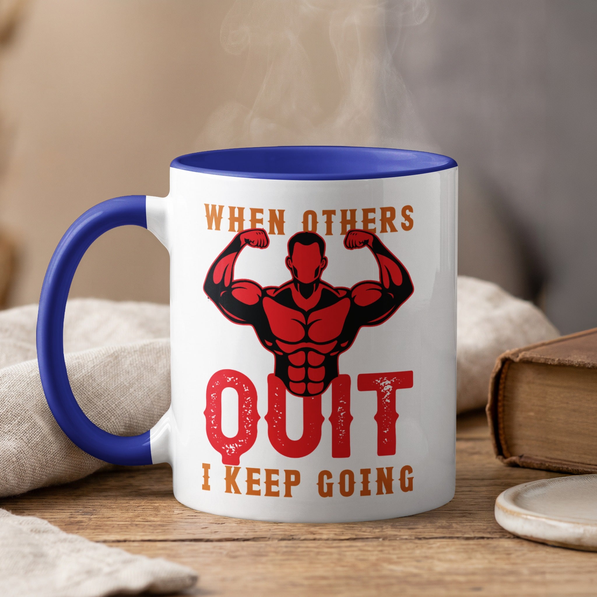 Mug with "WHEN OTHERS QUIT I KEEP GOING" text and muscular man graphic.