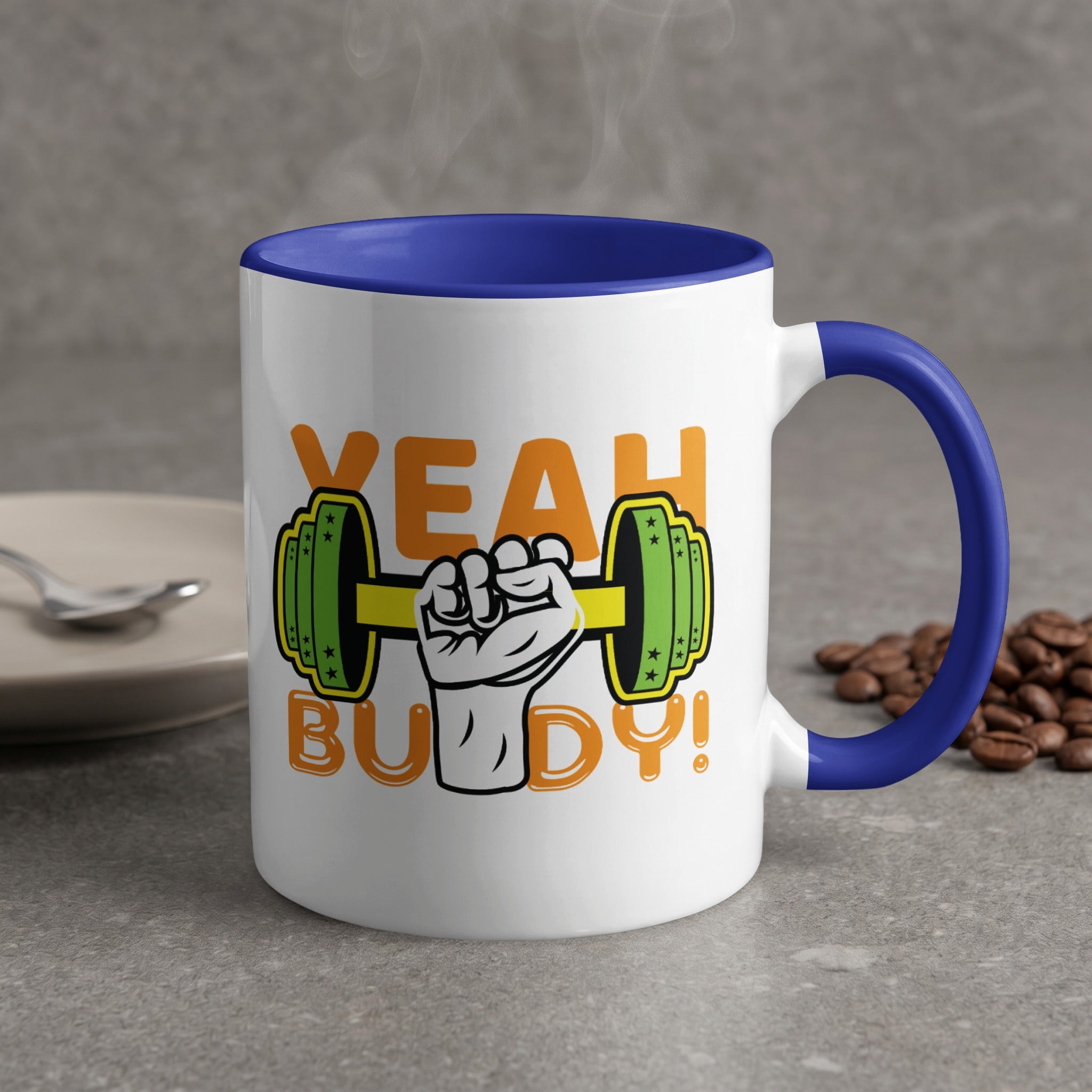 White mug with blue handle, saying "YEAH BUDDY!" with a dumbbell.