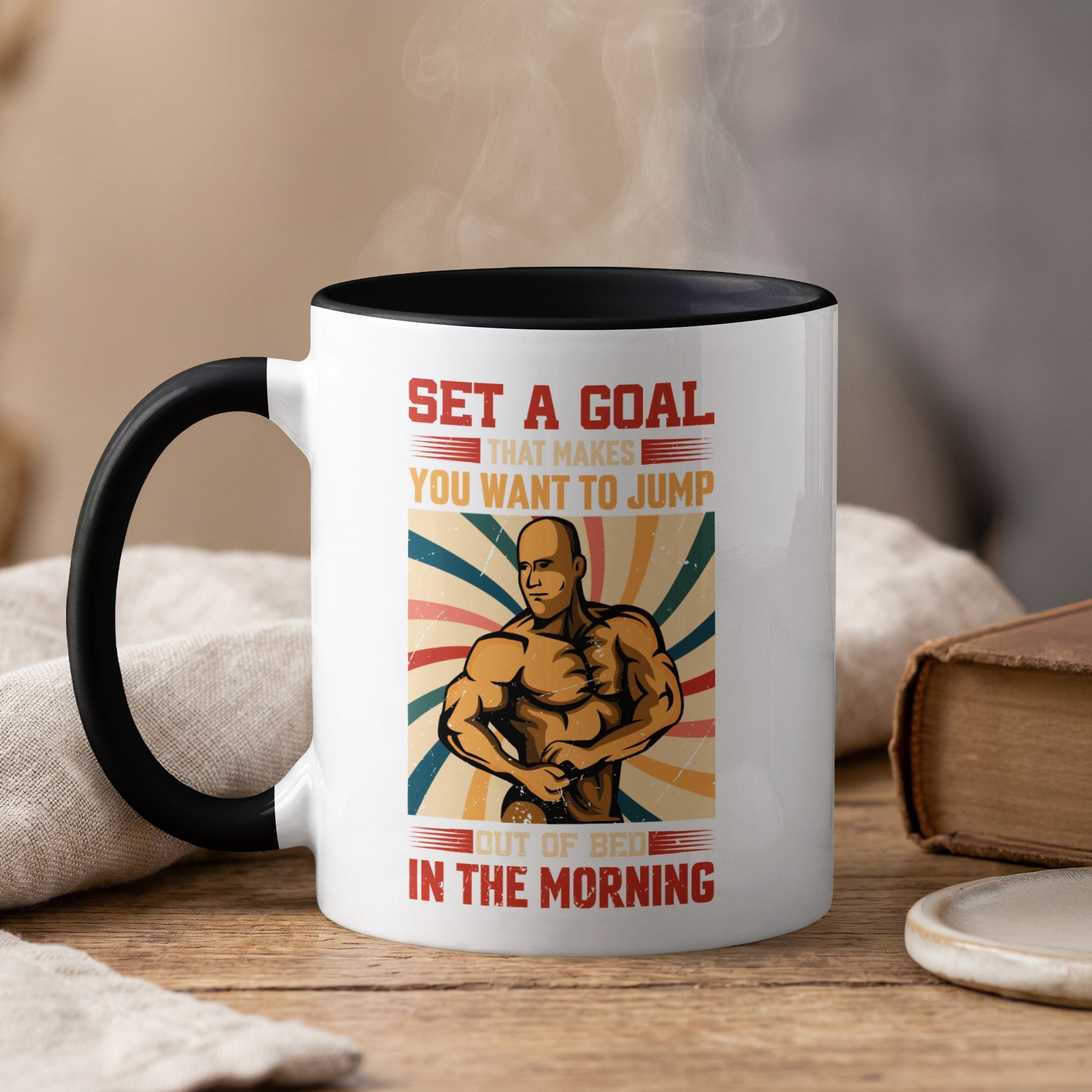 Mug with muscular man and motivational text "Set a goal that makes you want to jump out of bed in the morning."