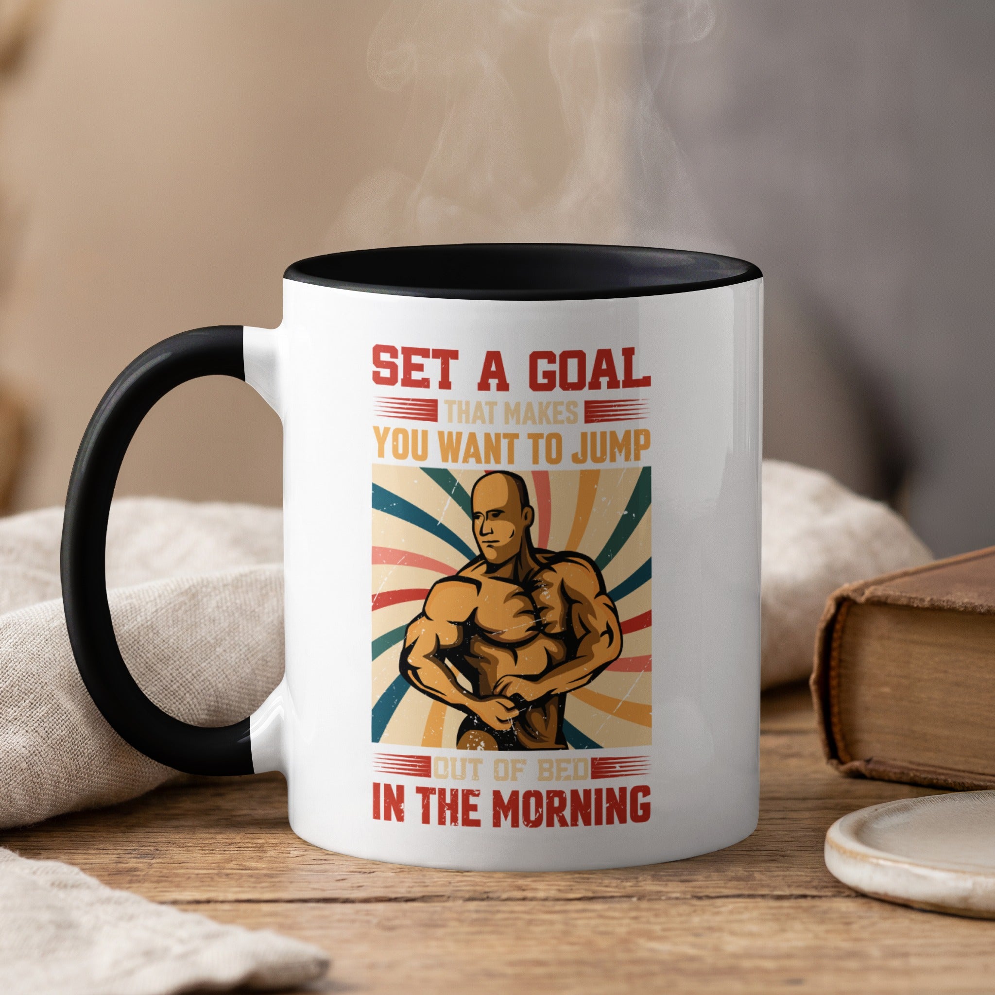 Mug with muscular man and motivational text "Set a goal that makes you want to jump out of bed in the morning."