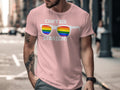 Pink t-shirt with white text and sunglasses featuring rainbow stripes.