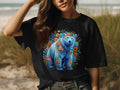 Black t-shirt featuring a blue bear surrounded by colorful flowers and greenery.