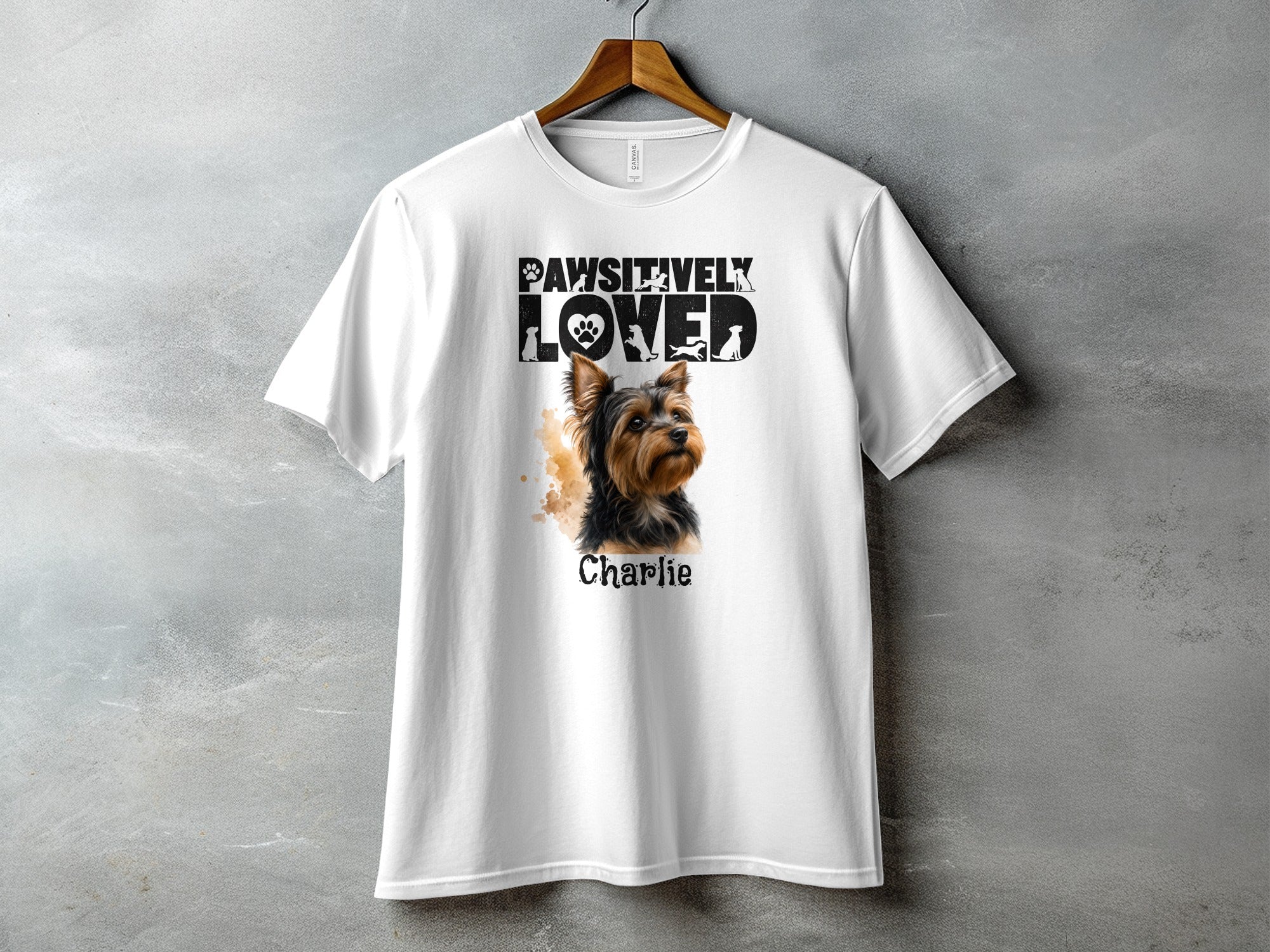 White t-shirt with "Pawsitively Loved" text and a Yorkshire Terrier named Charlie.
