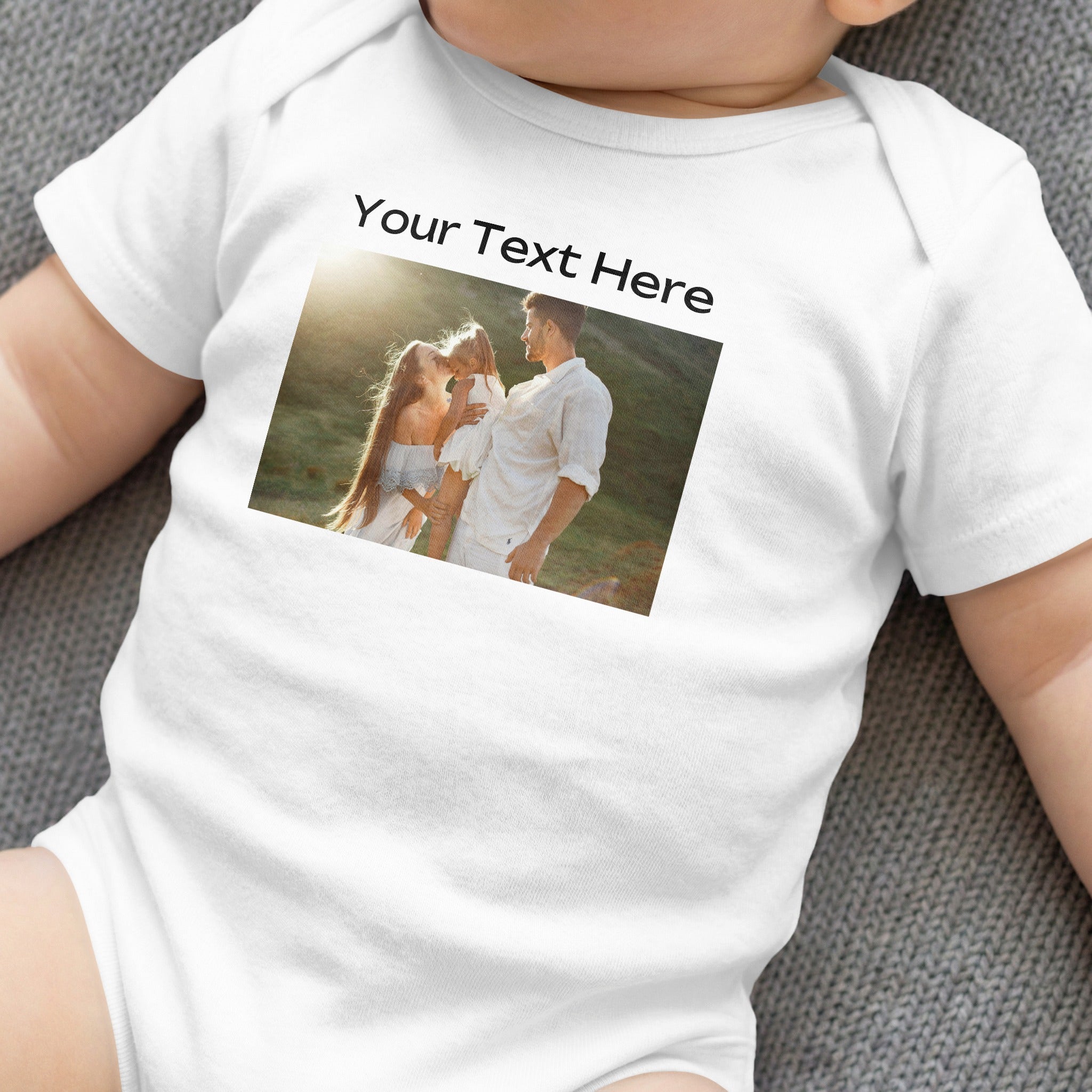 White baby onesie with custom photo and text overlay.