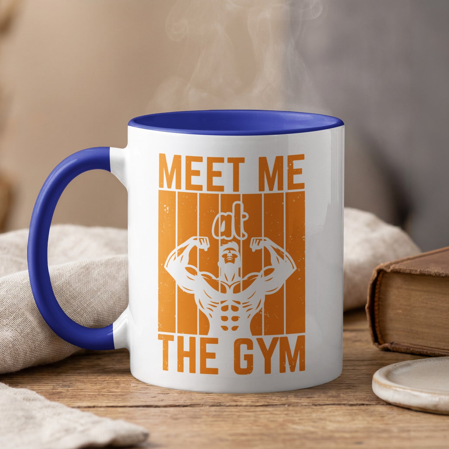 White mug with blue rim, featuring orange graphic and text "MEET ME THE GYM".