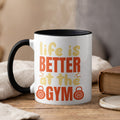 Mug with text "life is BETTER at the GYM" and barbell graphics.