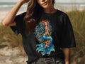 Black t-shirt with a colorful mermaid illustration and floral accents.