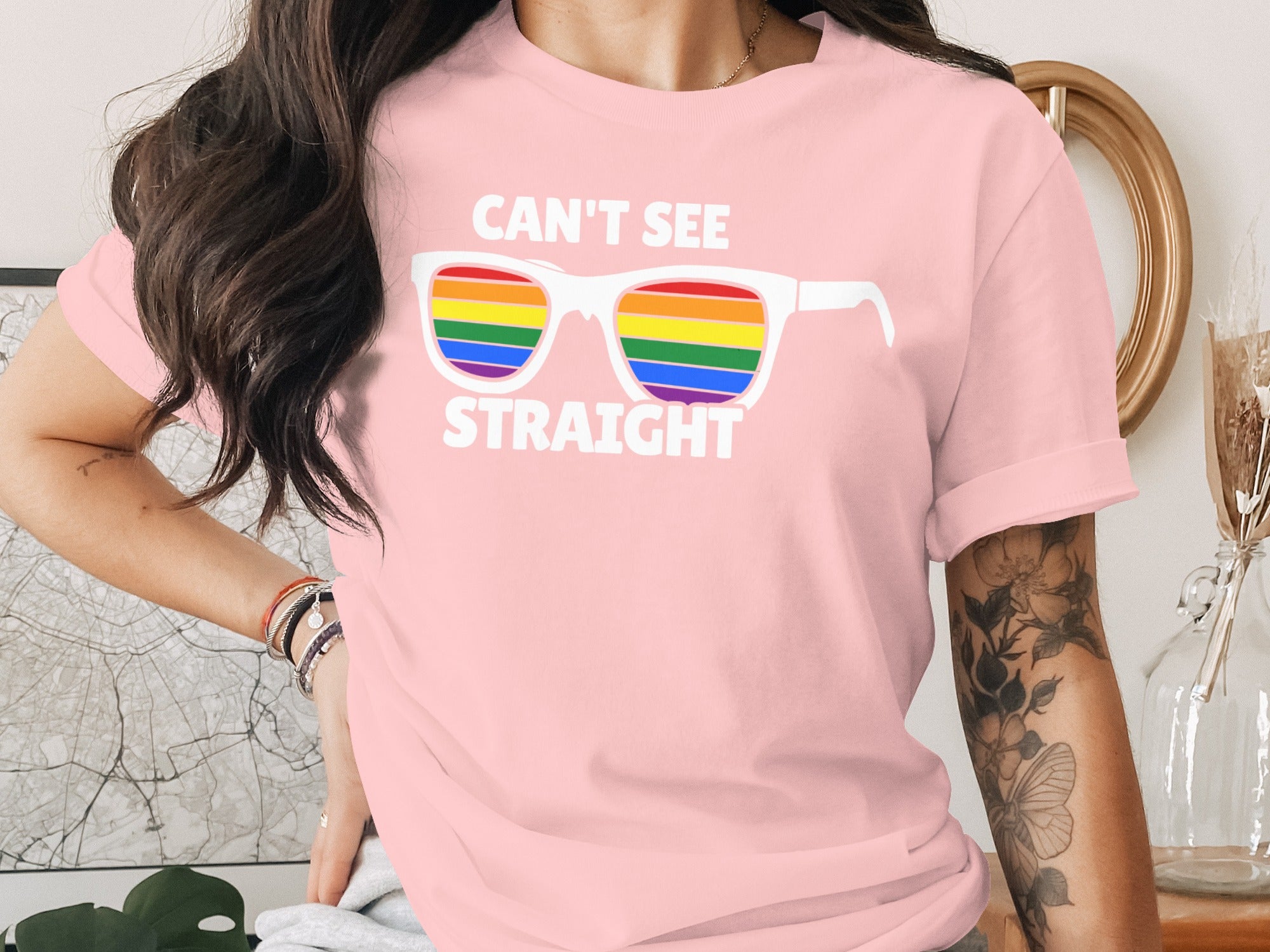 Pink t-shirt with rainbow sunglasses graphic and text "CAN'T SEE STRAIGHT".