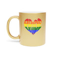Gold mug with rainbow pride heart design.