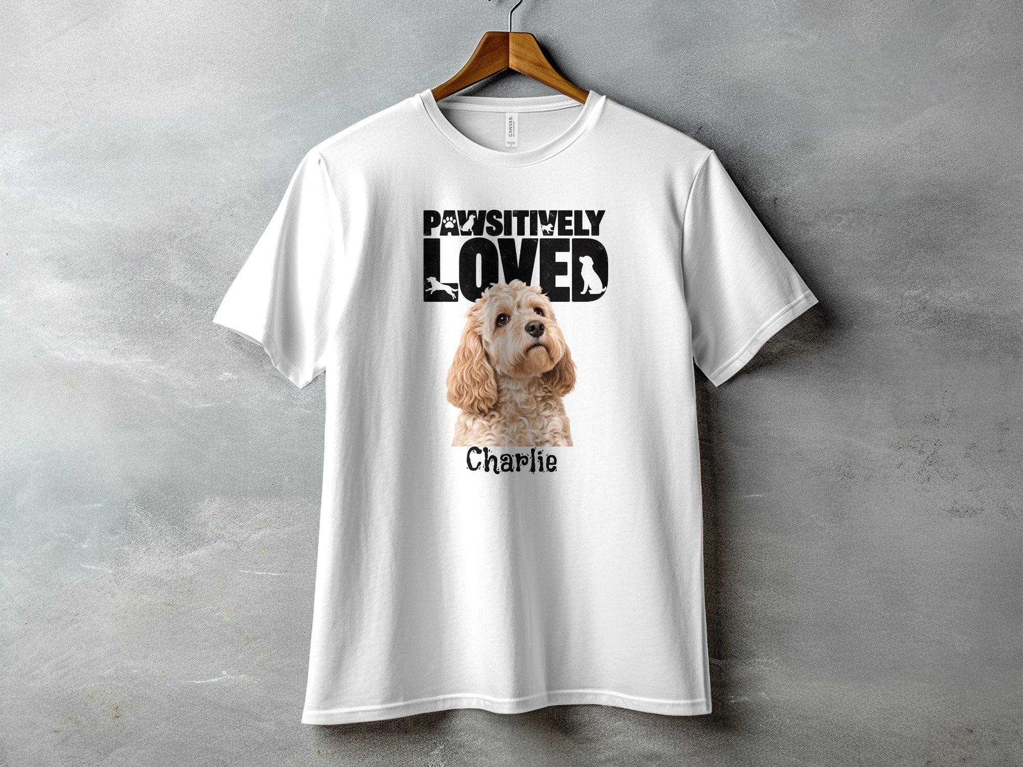 White t-shirt with "Pawsitively Loved" text and a dog named Charlie.