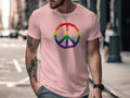 Pink t-shirt with rainbow peace sign graphic on chest.