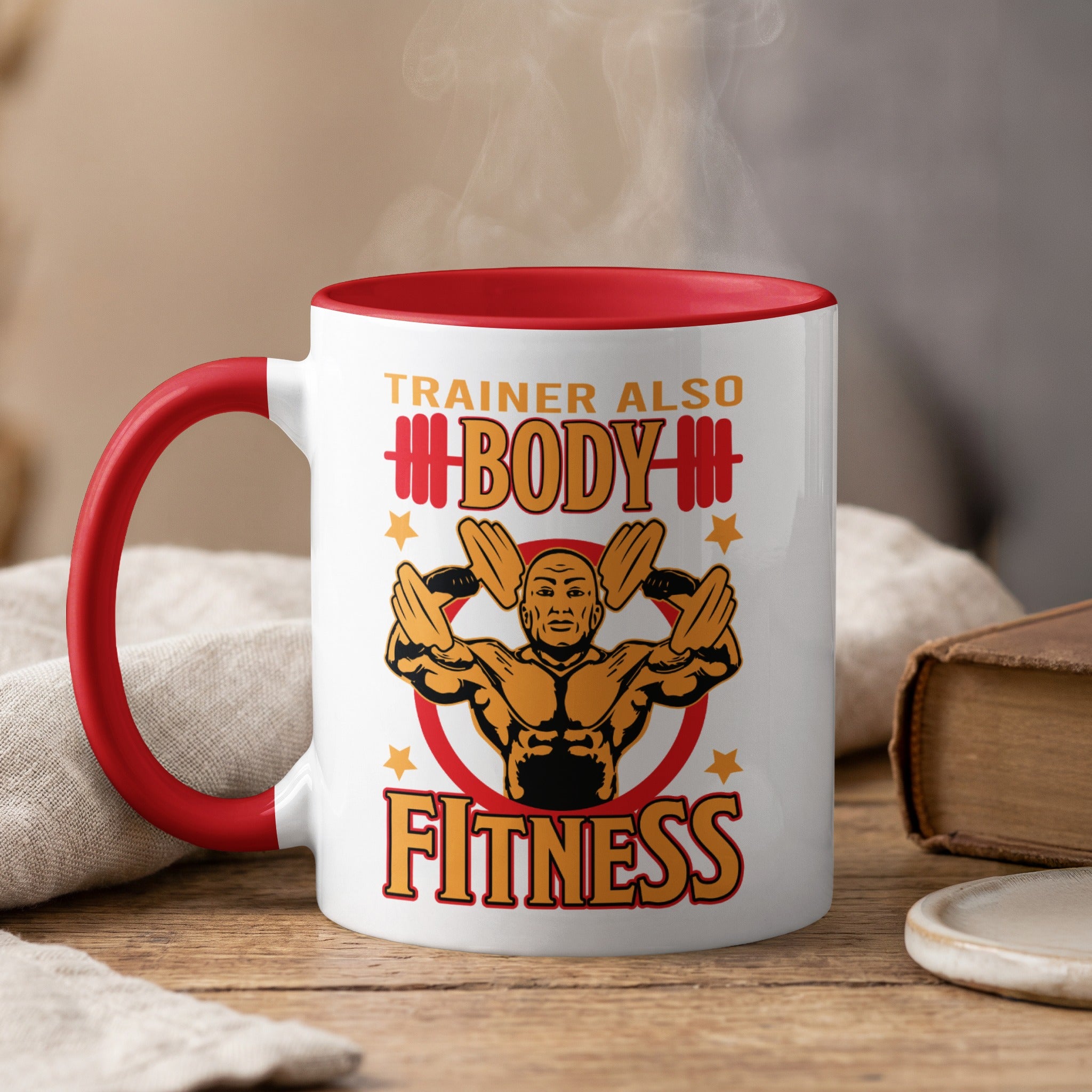 Trainer Also Body Fitness mug with steaming beverage.