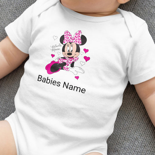 White baby onesie with Minnie Mouse, pink bow, and customizable "Babies Name".