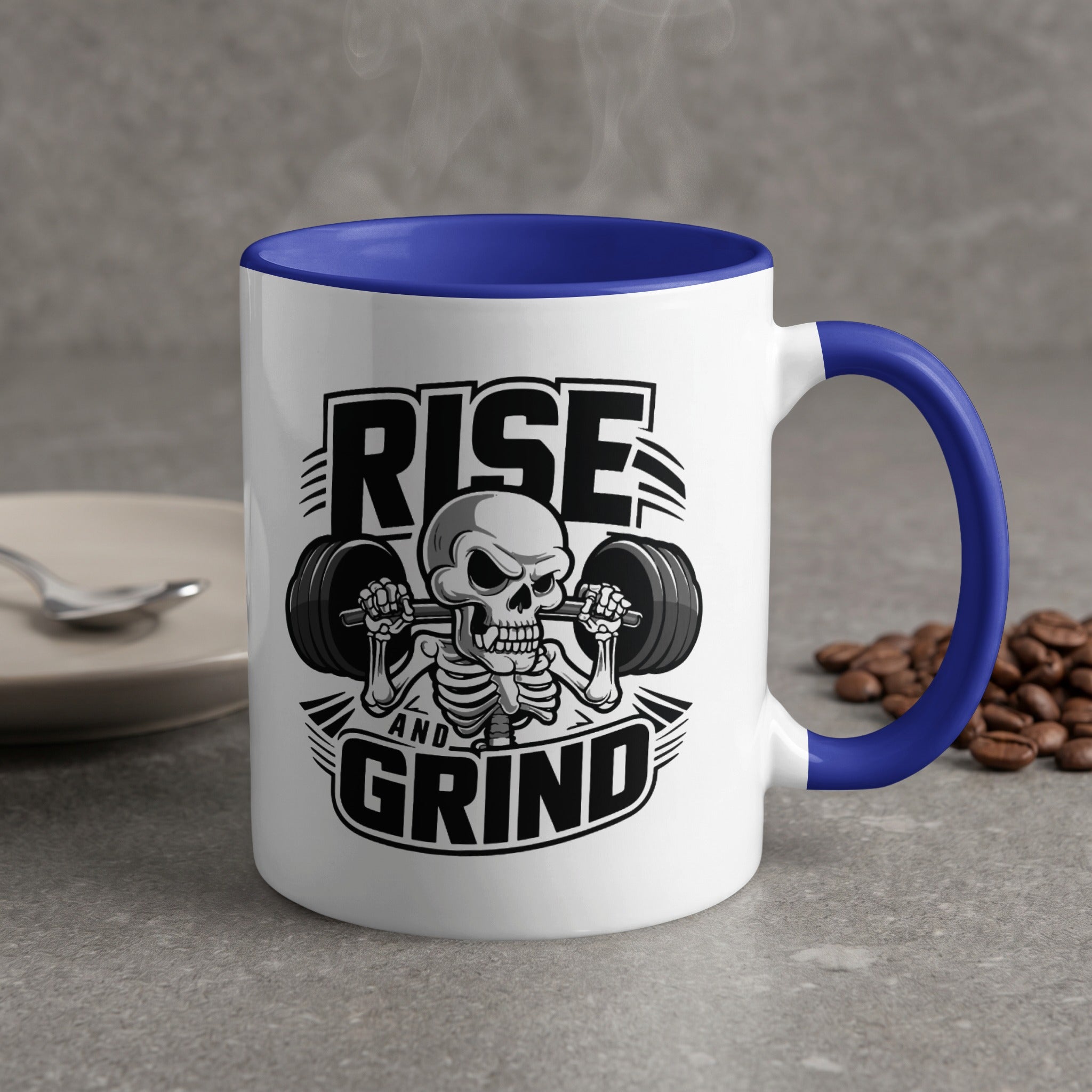 White mug with blue handle, "Rise and Grind" text, skeleton lifting weights.