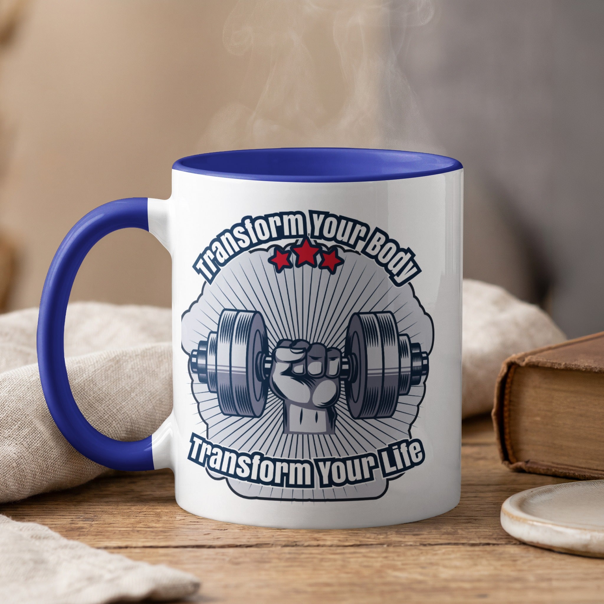 White mug with blue rim and handle, featuring a dumbbell and "Transform Your Body Transform Your Life" text.