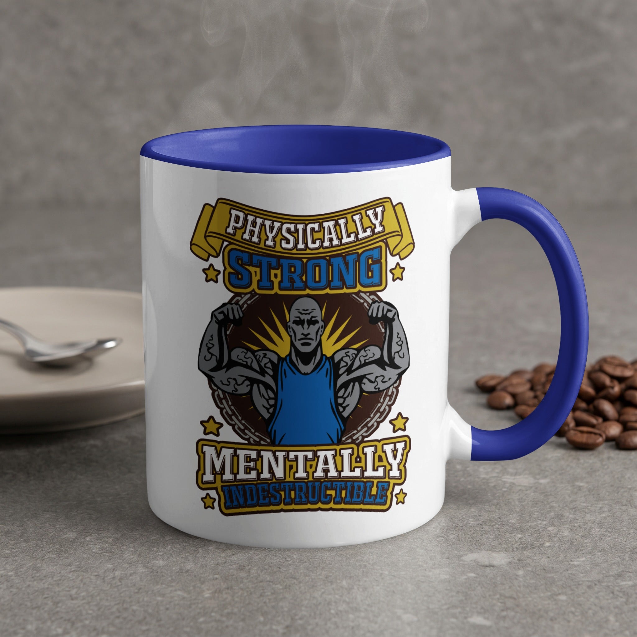 White mug with blue handle, "Physically Strong Mentally Indestructible" text and muscular man graphic.