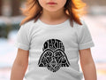 Child in white t-shirt with Darth Vader's helmet made of text.