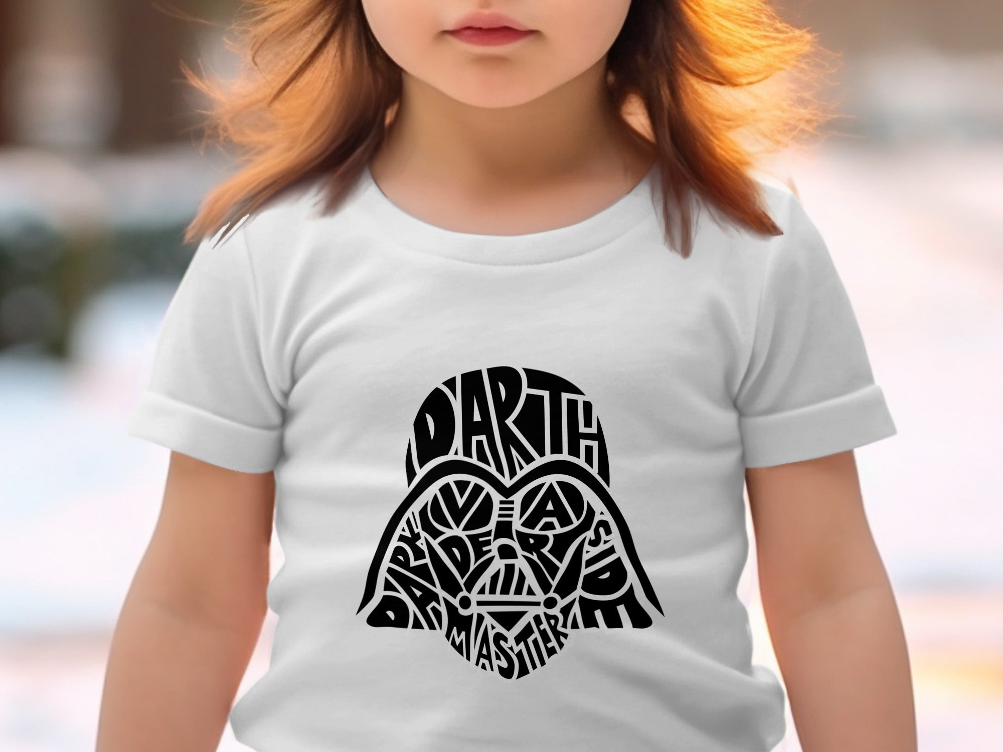 Child in white t-shirt with Darth Vader's helmet made of text.