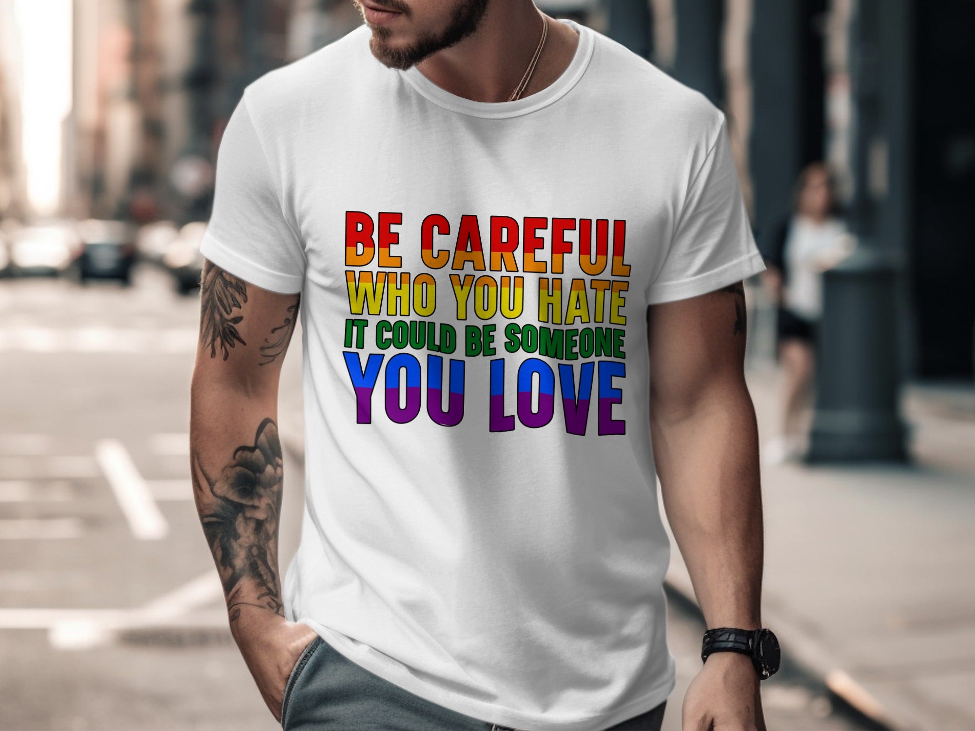 White t-shirt with rainbow text that reads "Be careful who you hate, it could be someone you love."