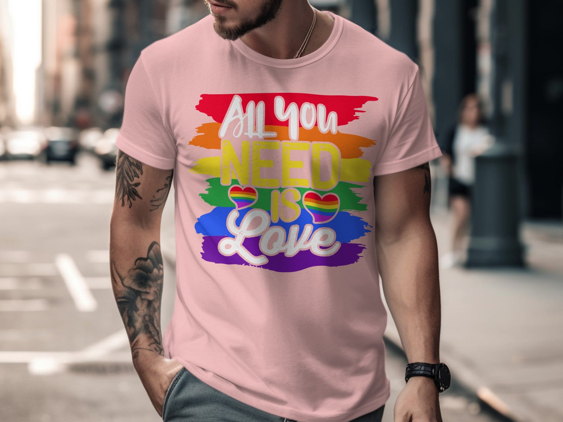 Pink t-shirt with "All you NEED is Love" and rainbow brush strokes.