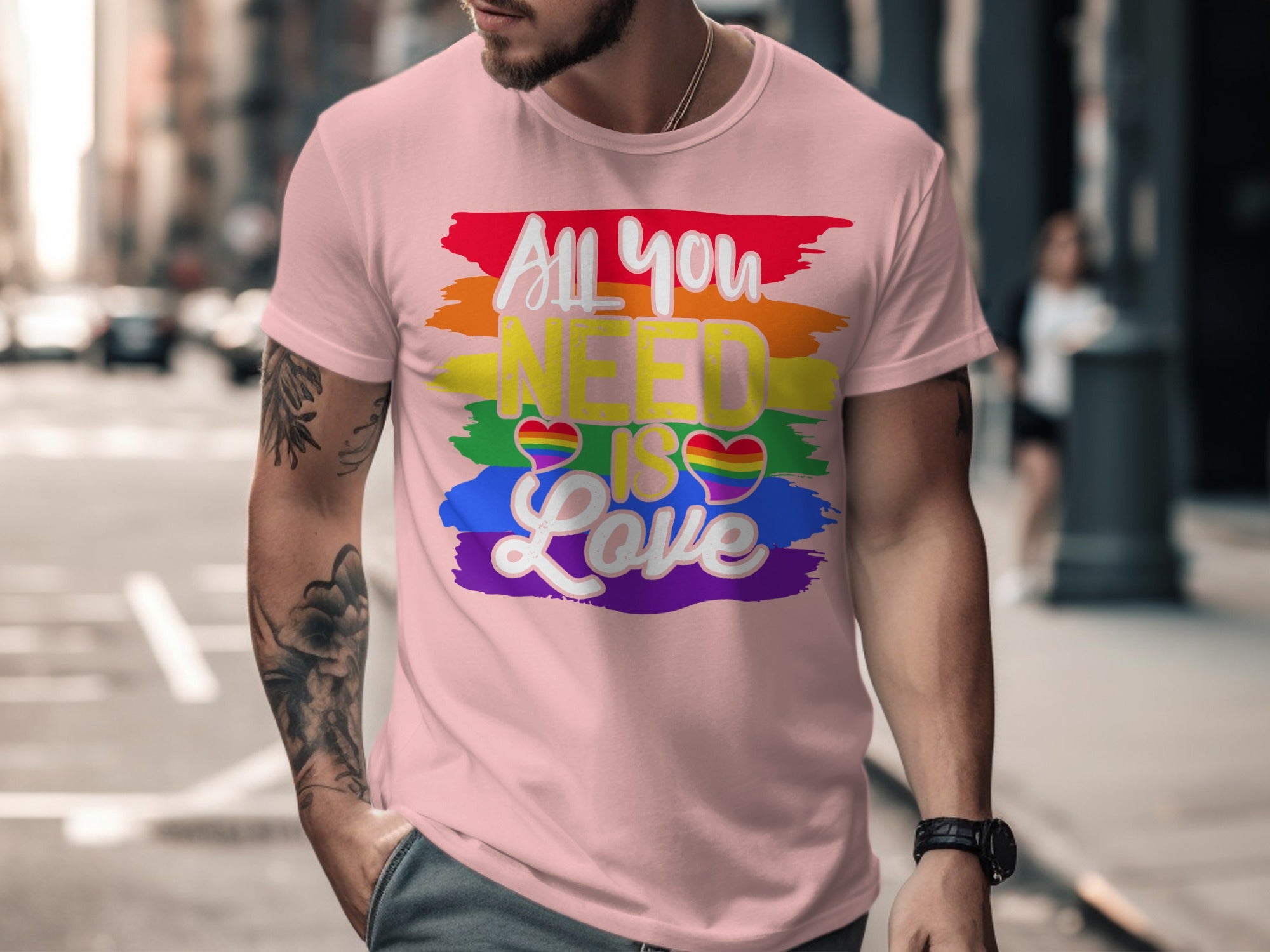 Pink t-shirt with "All you NEED is Love" and rainbow brush strokes.