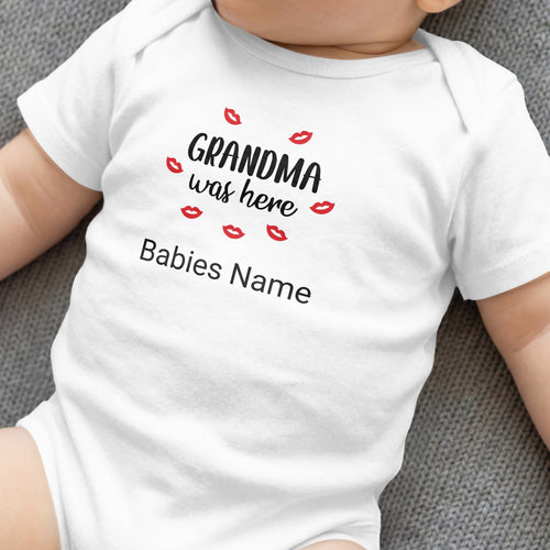 White baby onesie with red lips and text "Grandma was here" and "Babies Name".
