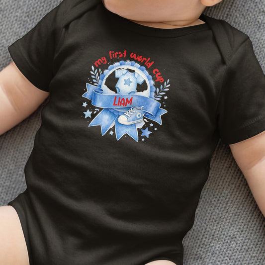 Black baby onesie with "my first world cup" text and a soccer shoe.