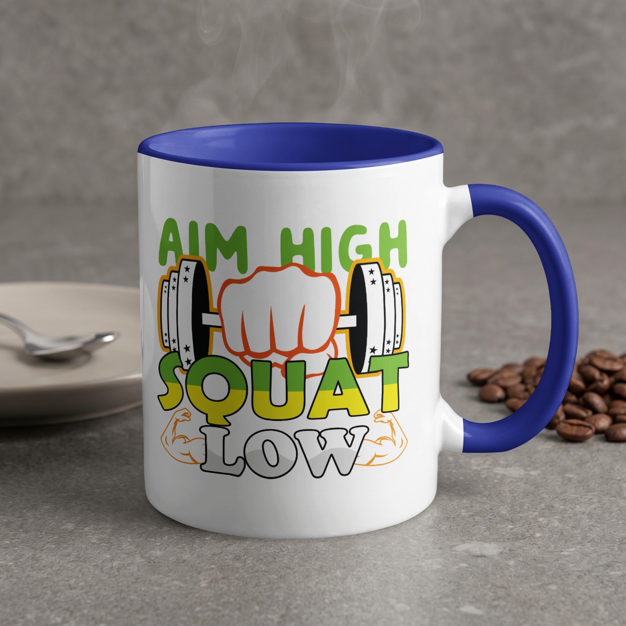 White mug with blue handle, "Aim High Squat Low" text and dumbbell graphics.