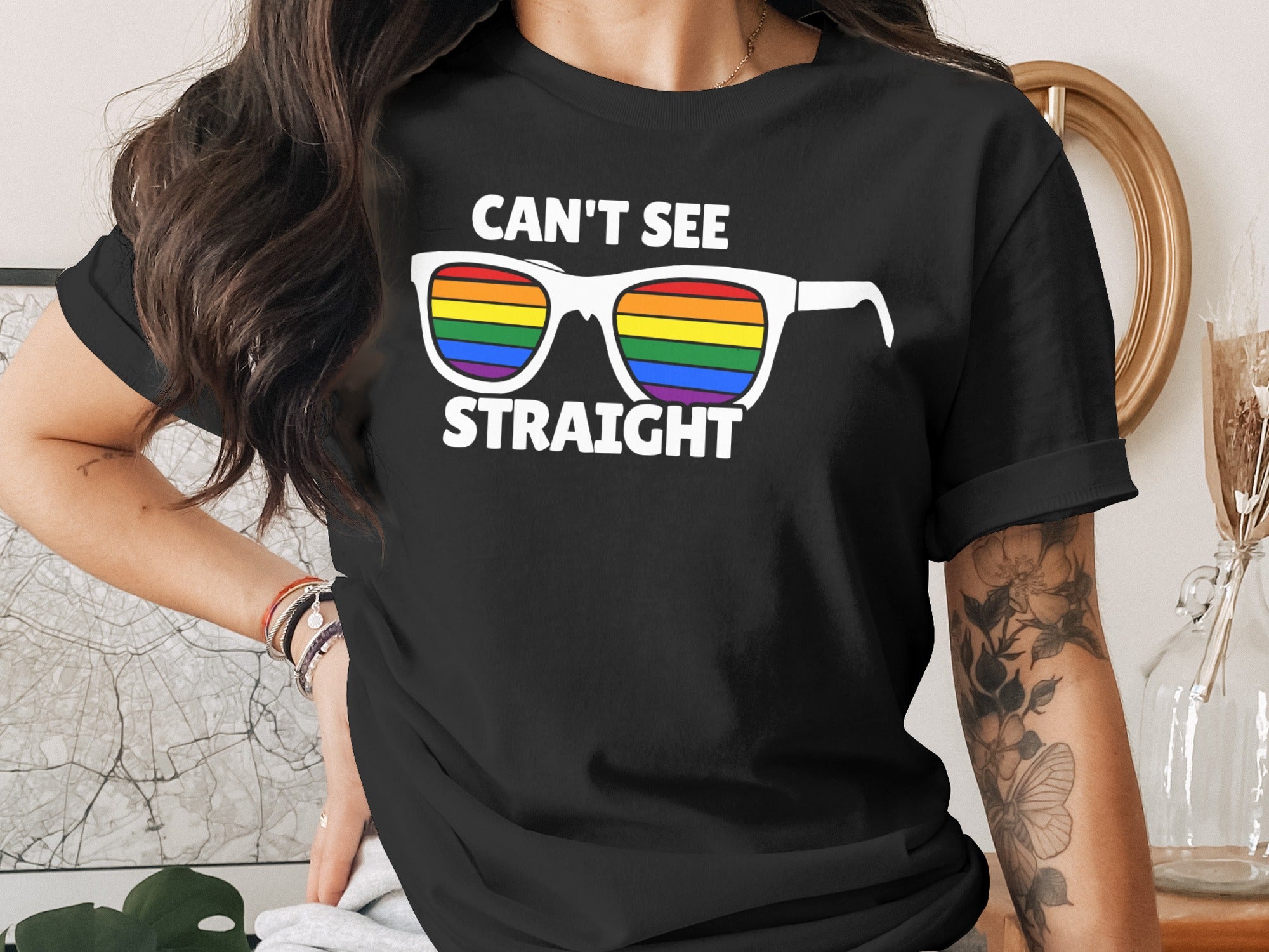 Black t-shirt with white sunglasses graphic and rainbow lenses reading "CAN'T SEE STRAIGHT".