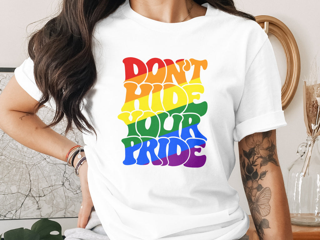 White t-shirt with rainbow text that says "Don't Hide Your Pride."