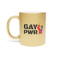 Gold mug with black text "GAY PWR" and a rainbow fist graphic.