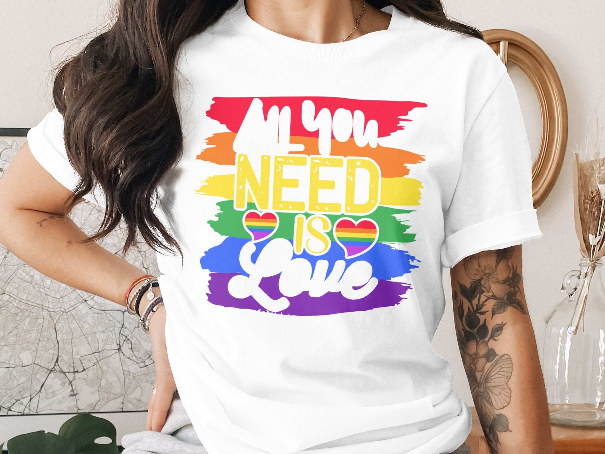 White t-shirt with rainbow stripes and "All you need is love" text.