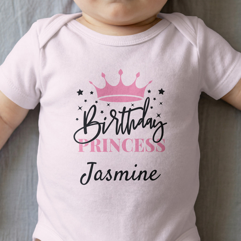 White baby onesie with pink "Birthday Princess Jasmine" text and crown.