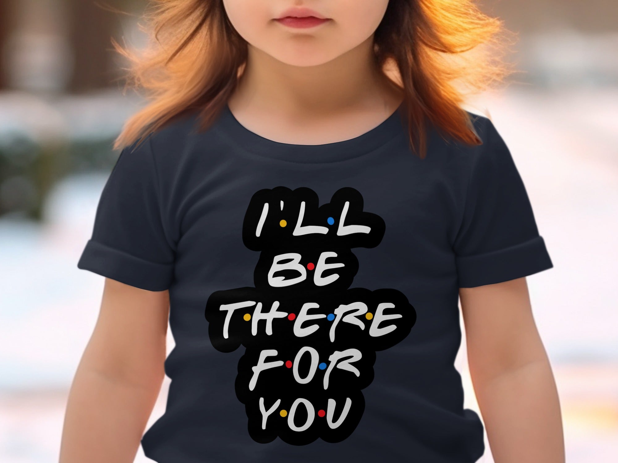 Child wearing a dark t-shirt with white text "I'LL BE THERE FOR YOU".