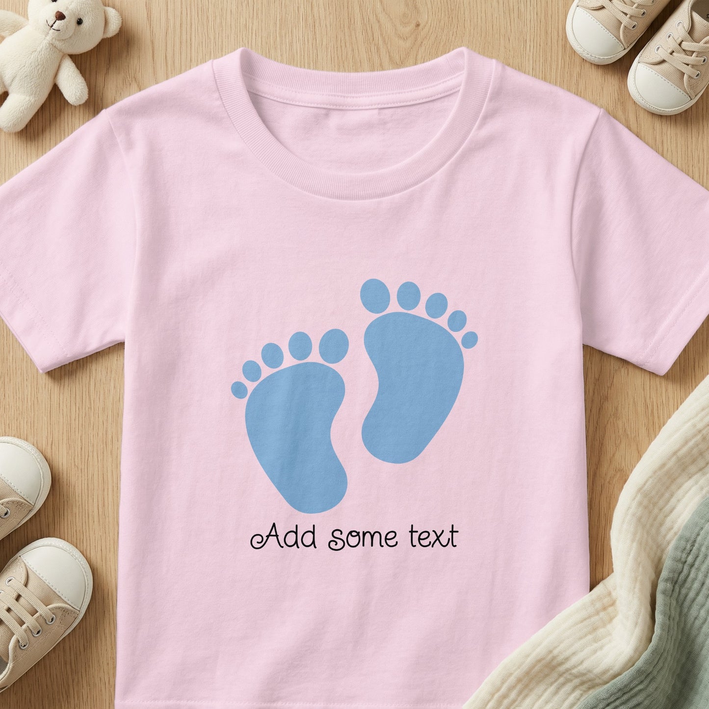 Pink t-shirt with blue footprints and customizable text.