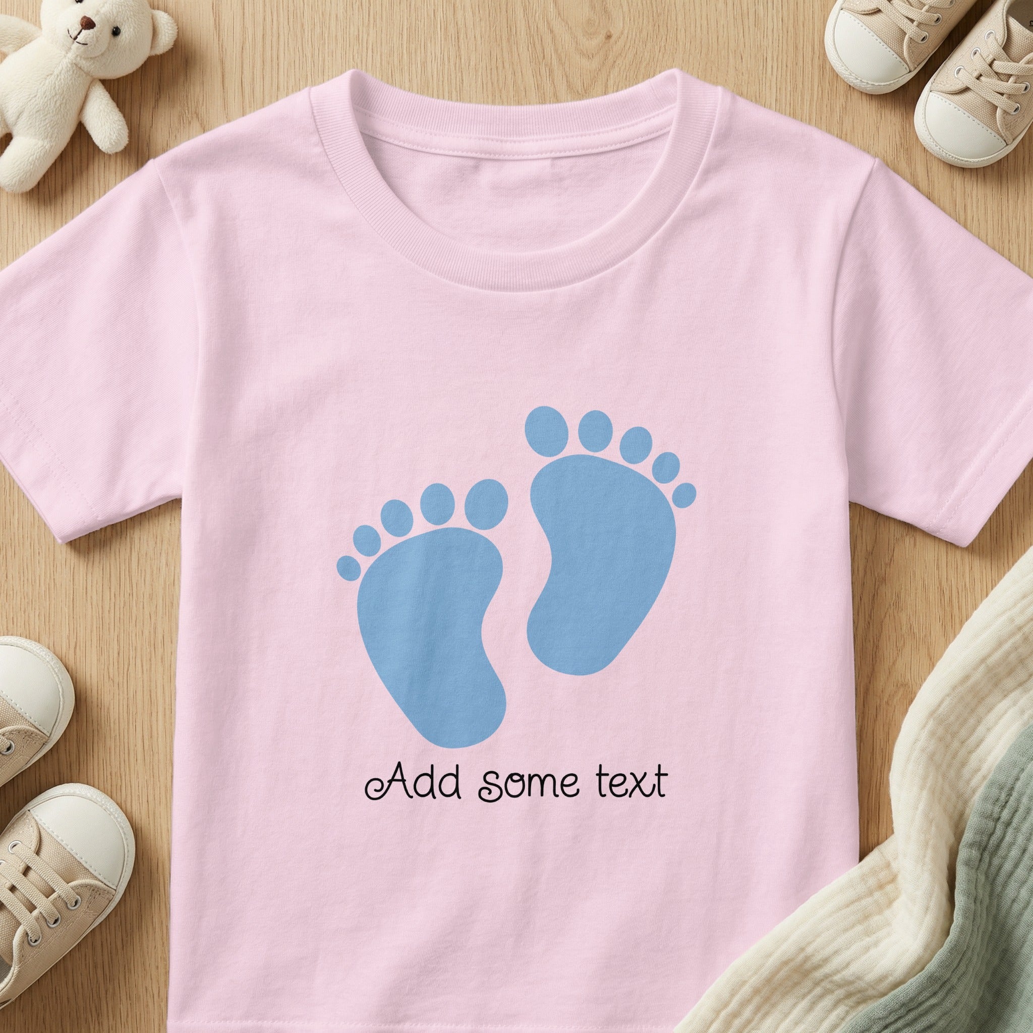 Pink t-shirt with blue footprints and customizable text.