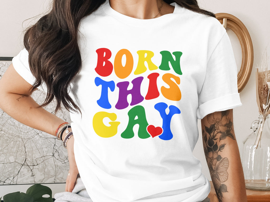 White t-shirt with "BORN THIS GAY" in colorful, bold, wavy lettering.