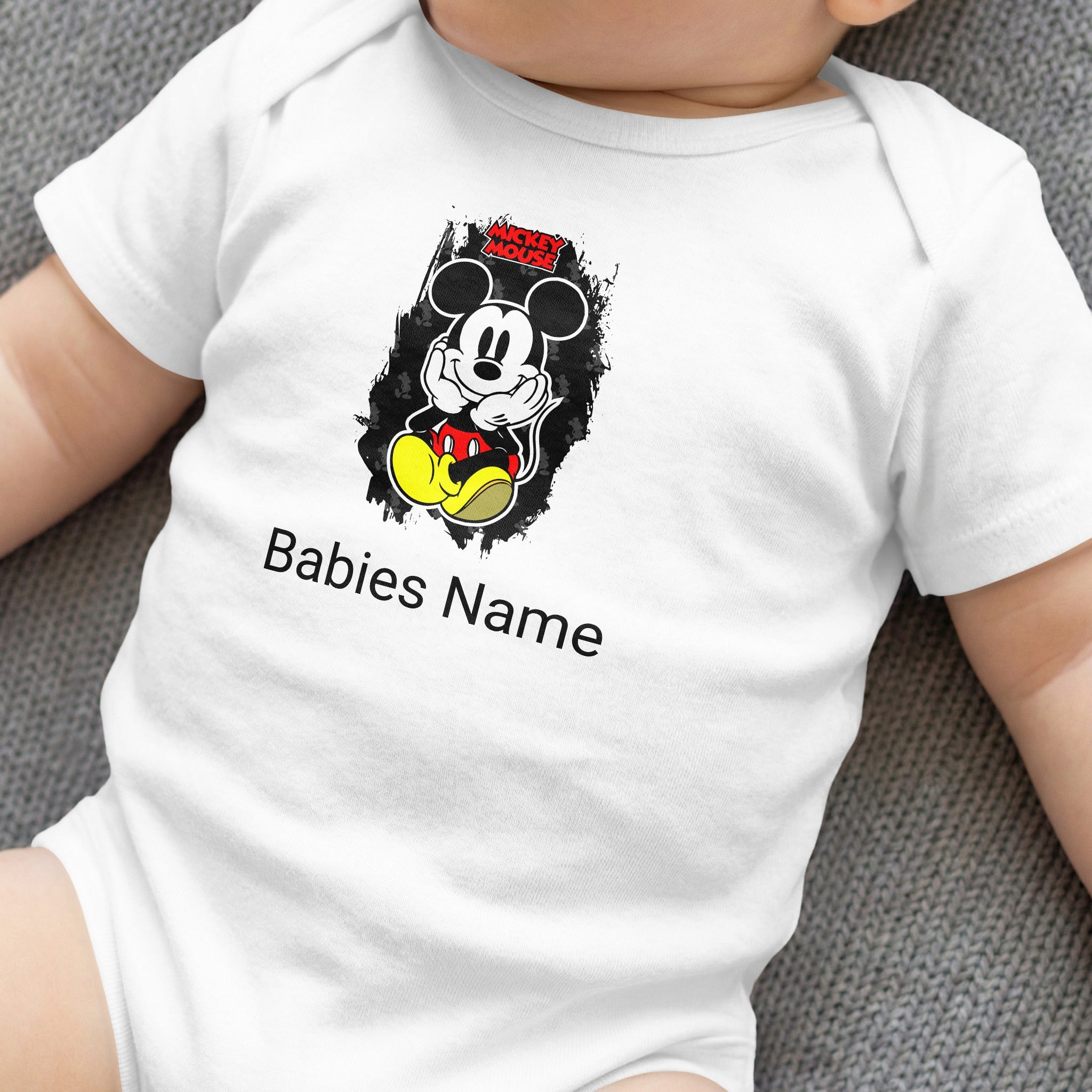White baby onesie with Mickey Mouse graphic and "Babies Name" text.