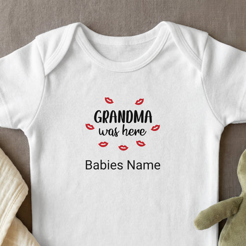 White baby onesie with red lips and text "Grandma was here", "Babies Name".