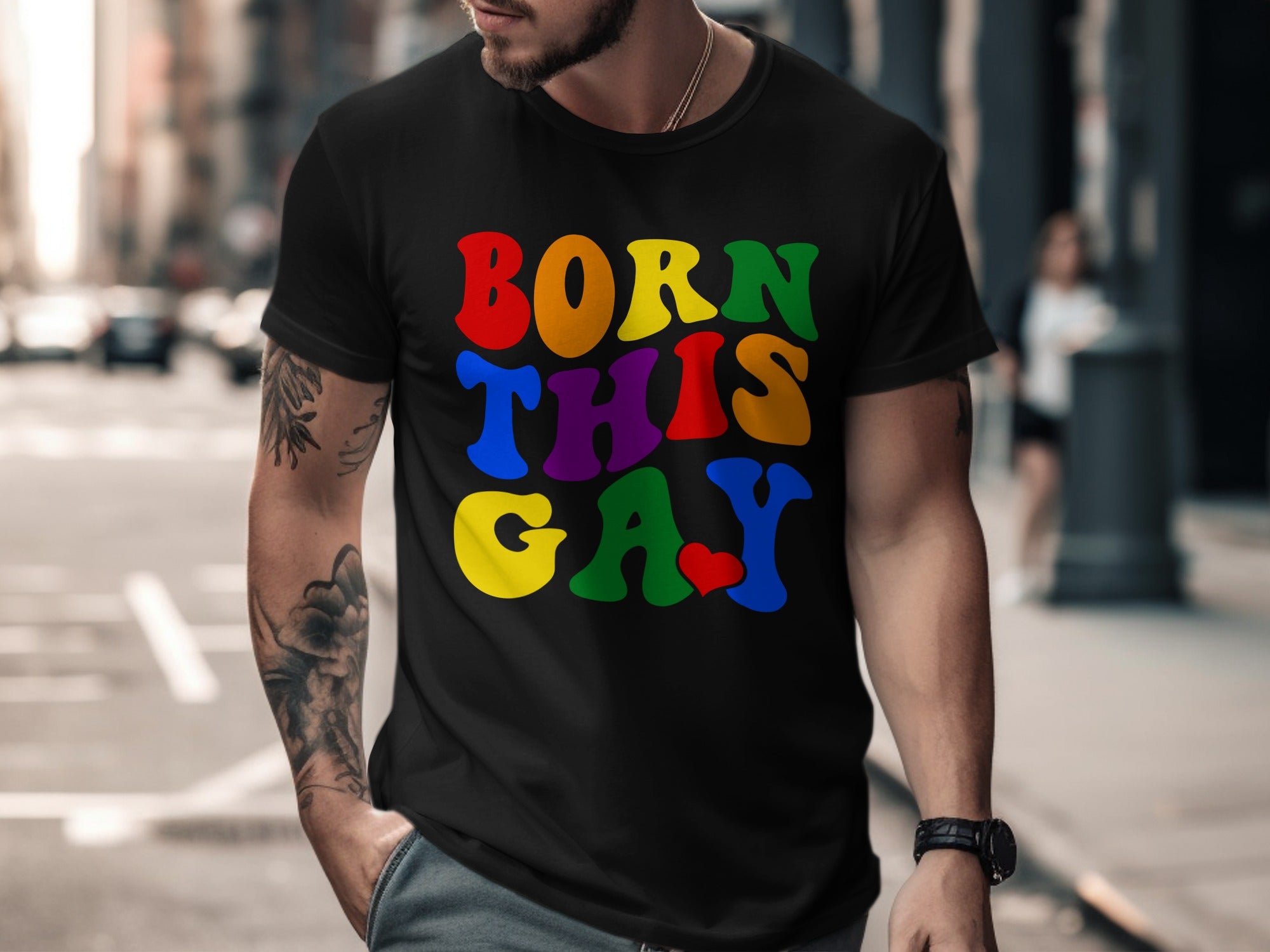 Black t-shirt with rainbow text "BORN THIS GAY" and a red heart.