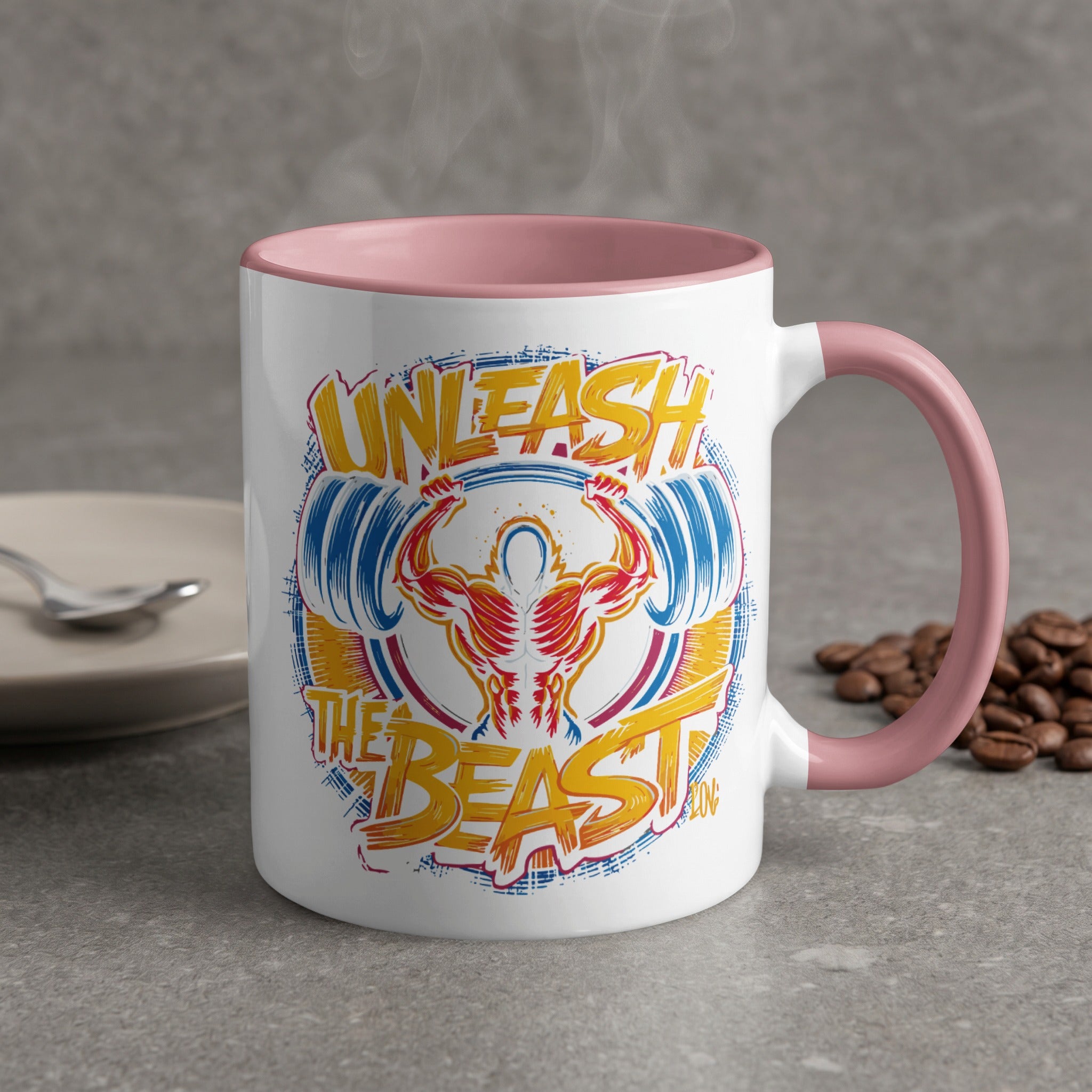 White mug with "Unleash The Beast" design and pink handle.