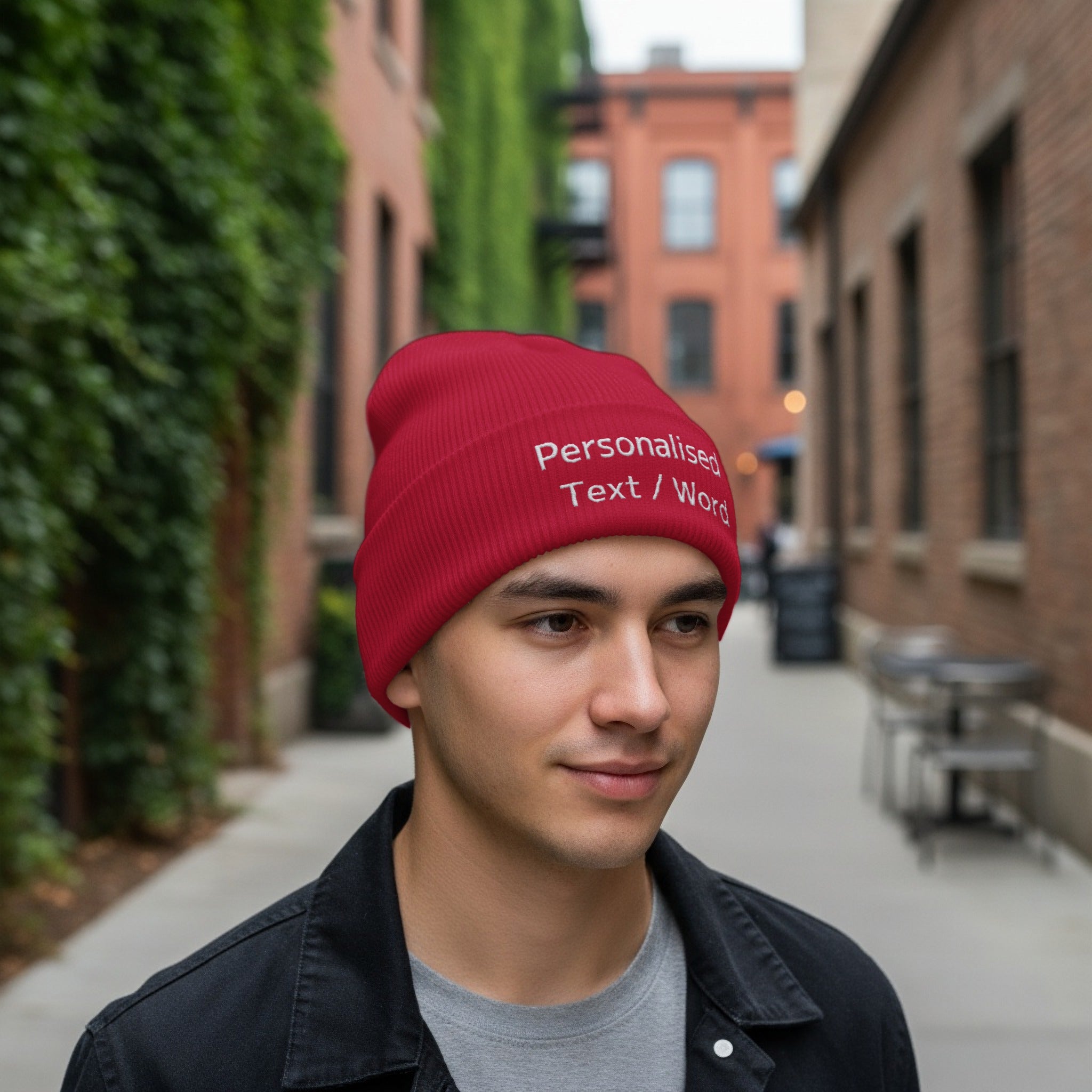 Red beanie with "Personalised Text / Word" embroidered on it, worn by a young man.
