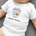 White baby bodysuit with "Our First Mother's Day" text and cartoon coffee and baby bottles.