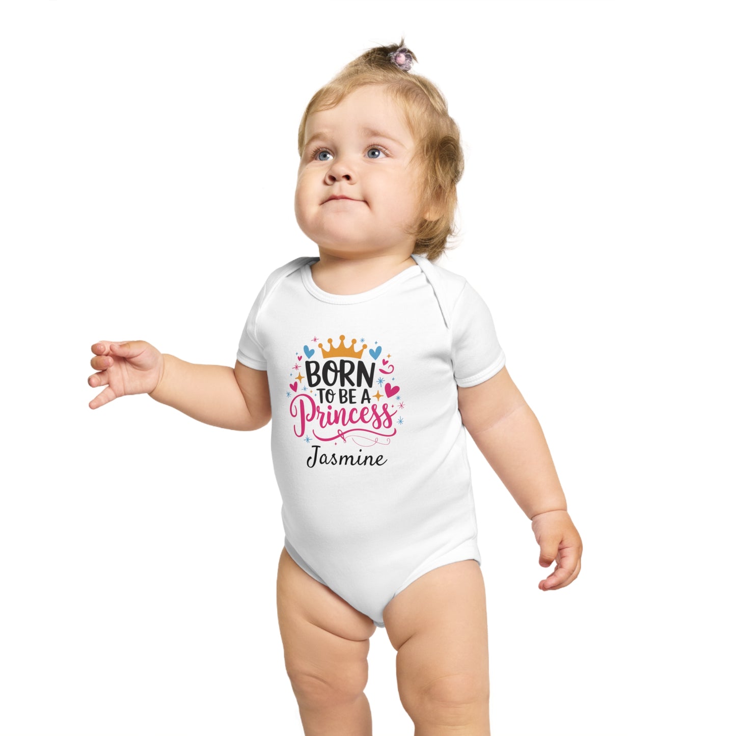 Baby girl in white bodysuit reading "Born to be a Princess Jasmine."