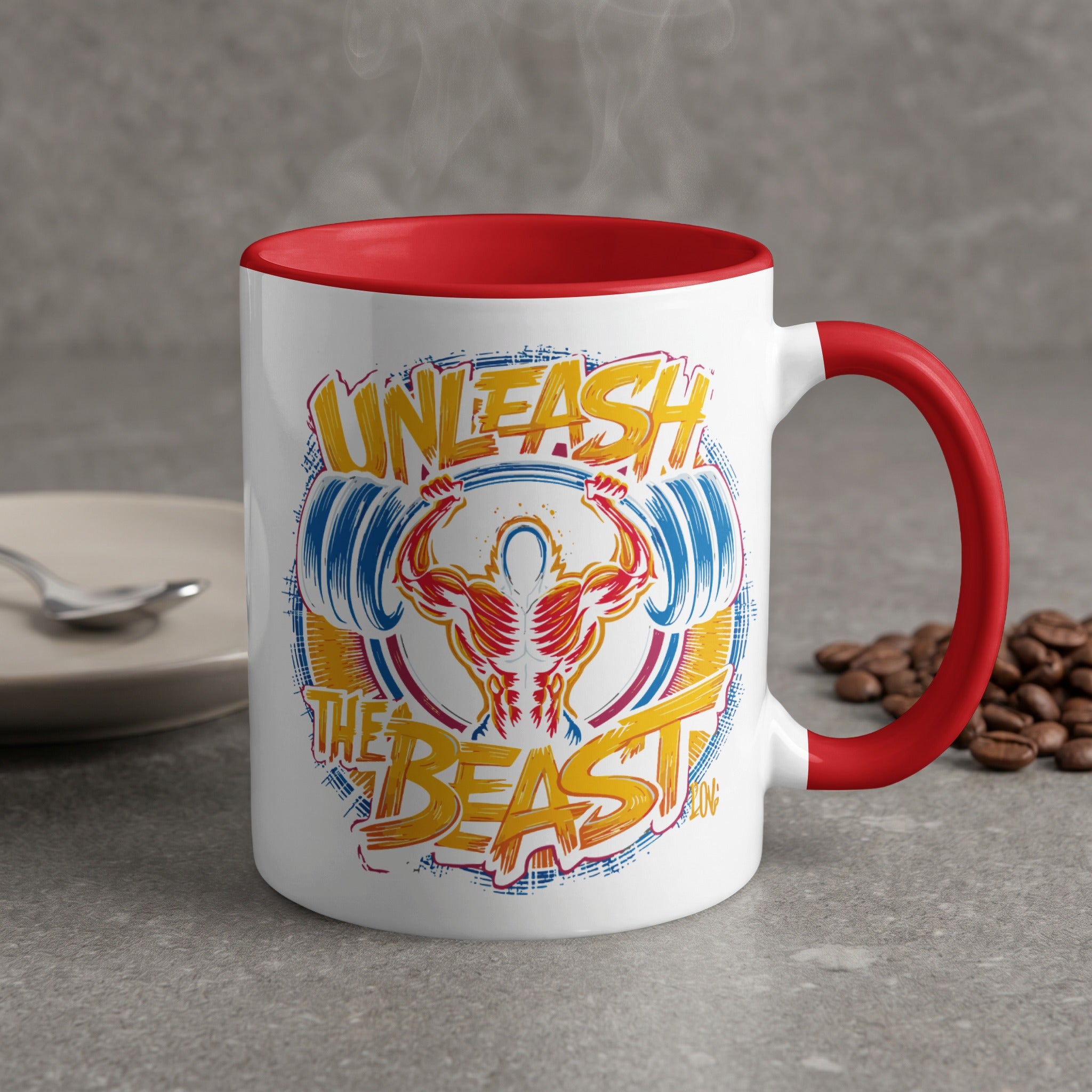 White mug with red handle, "Unleash the Beast" weightlifting graphic.