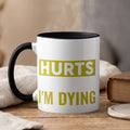 White mug with black handle, steaming, displaying text "HURTS I'M DYING".