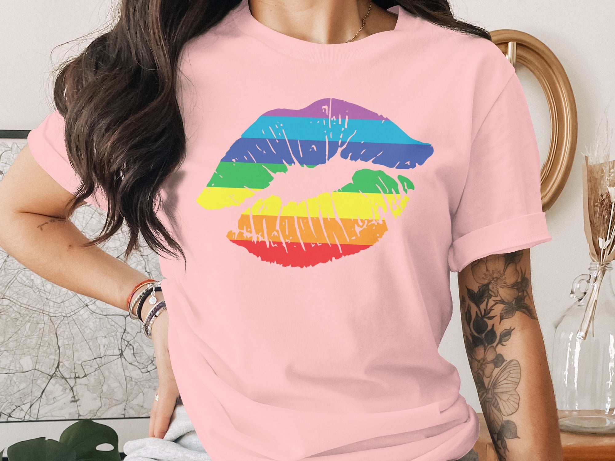 Pink t-shirt with rainbow lip print and floral arm tattoo.
