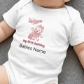 White baby bodysuit with "my first holiday" and cartoon plane and baby.