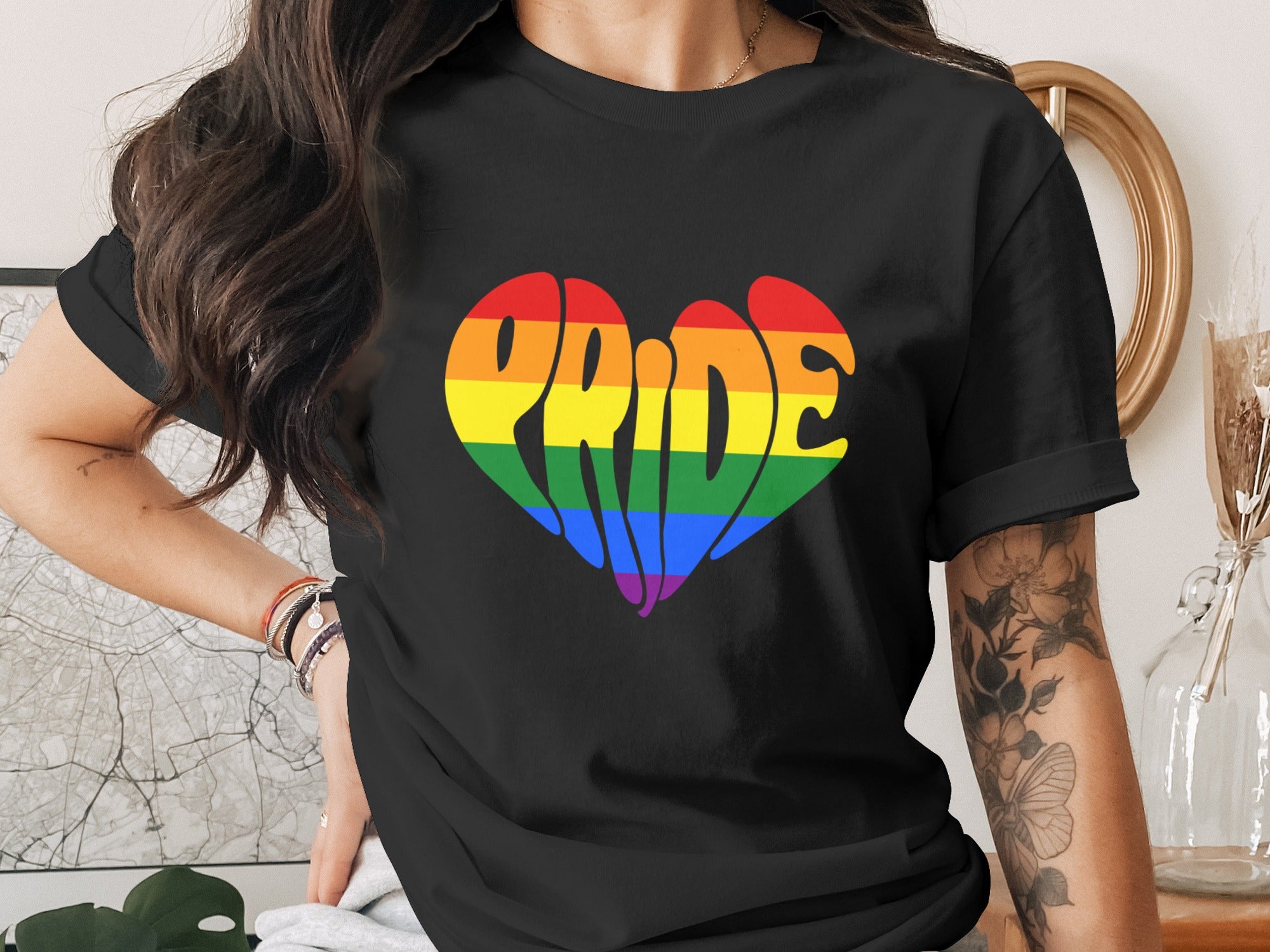 Black t-shirt with rainbow heart graphic stating "Pride".